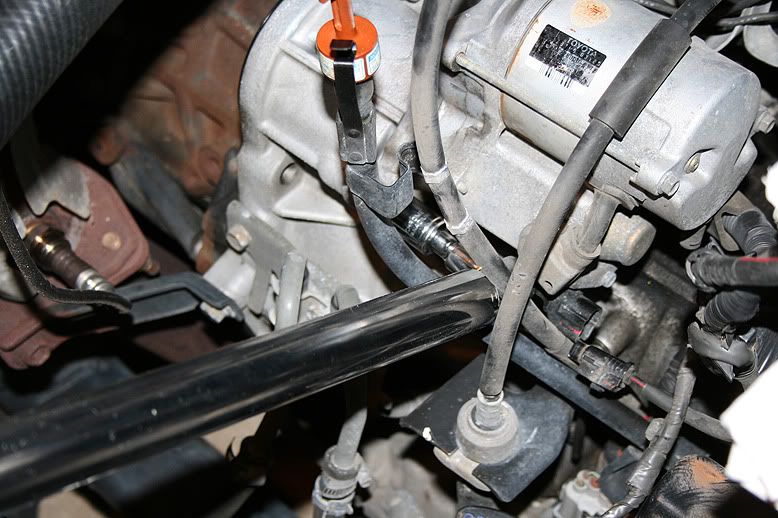 Where is the starter located in a 2003 toyota camry