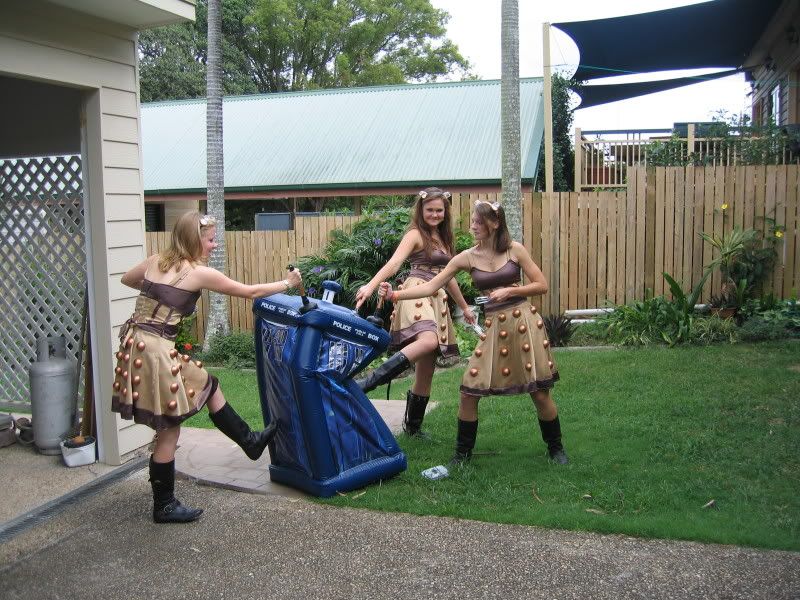 Three Dalek girls kicking the shit out of an inflatable Tardis