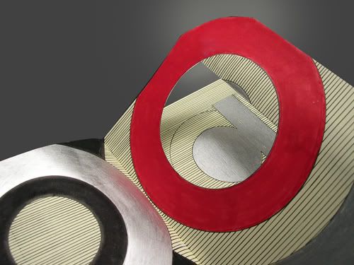 Close up of Letter O. When You Lift the Page, You Can See How the Cut Out Was Formed that Creates an O on the Front Side and a P on the Reverse.
