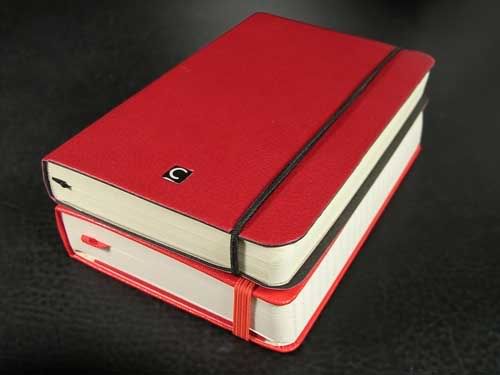 Cartesio stacked on a Moleskine planner. The outer dimensions of the Cartesio and Moleksine are the same 3½ X 5½. The Cartesio s cover is made from recycled leather, the Moleskines is oilcloth.